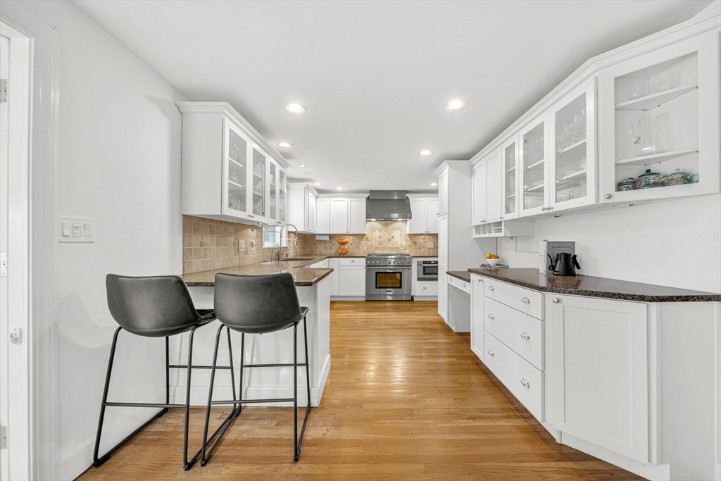 69 Donizetti Street Wellesley, MA 02482 - Photo 7 of 29 a kitchen with granite countertop a counter space a sink appliances and cabinets