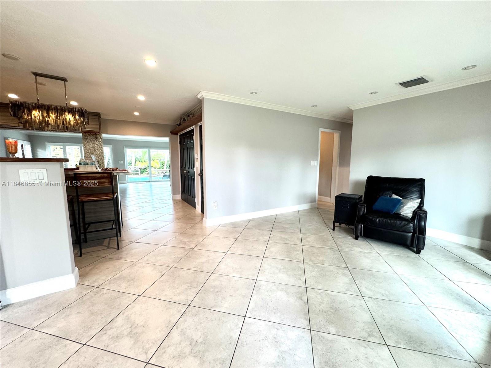 9385 Southwest 185th Street Cutler Bay, FL 33157 - Photo 12 of 27 a living room with furniture a dining table and kitchen view