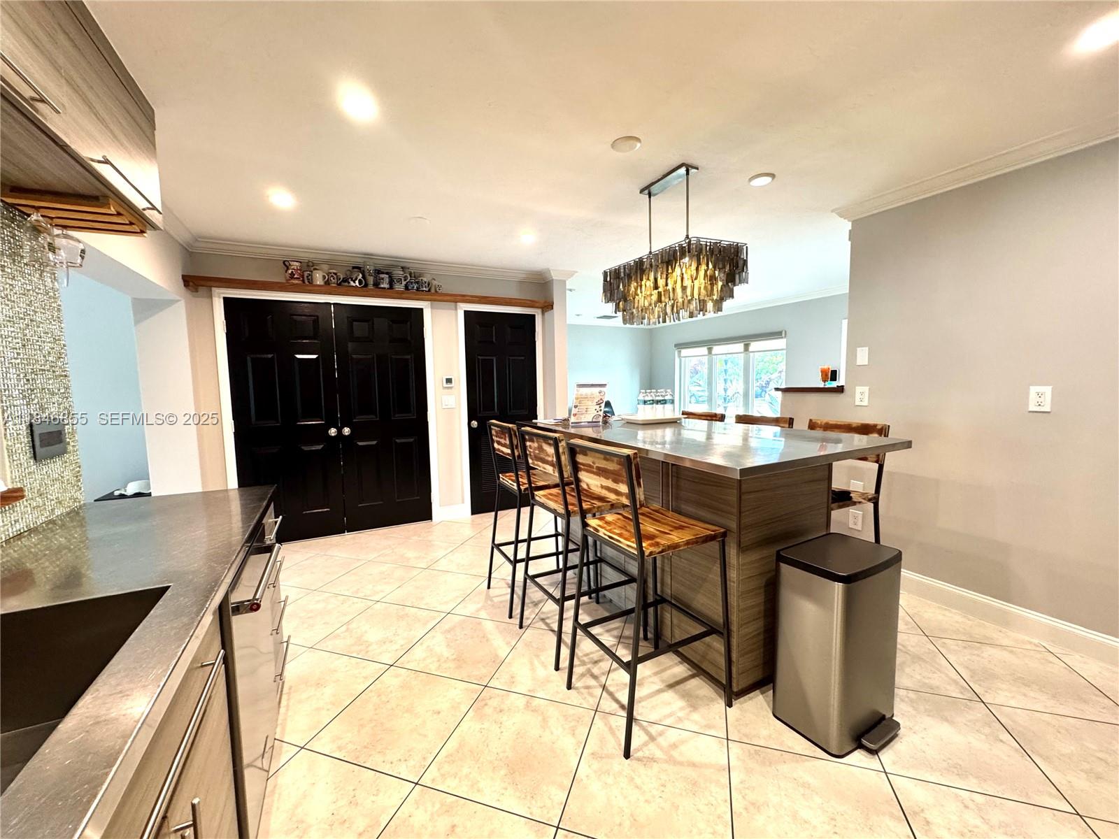 9385 Southwest 185th Street Cutler Bay, FL 33157 - Photo 13 of 27 a kitchen with a table and chairs in it