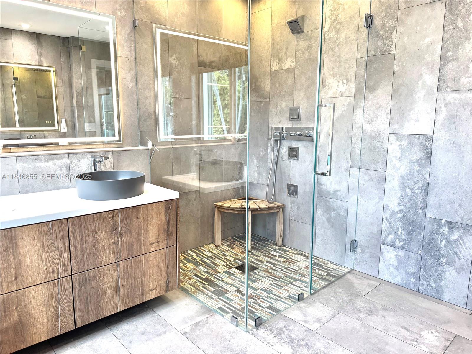 9385 Southwest 185th Street Cutler Bay, FL 33157 - Photo 19 of 27 a spacious bathroom with a mirror and a shower