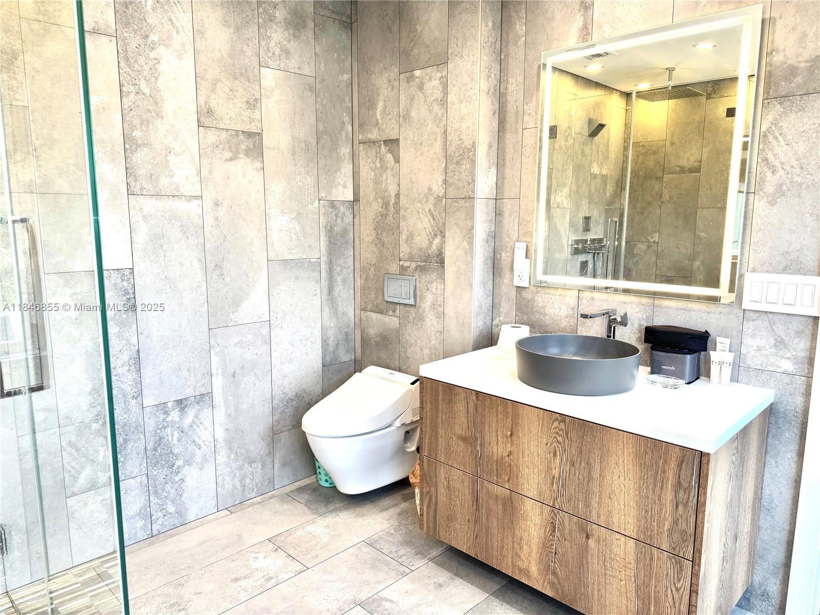 9385 Southwest 185th Street Cutler Bay, FL 33157 - Photo 21 of 27 a bathroom with a sink a toilet and shower