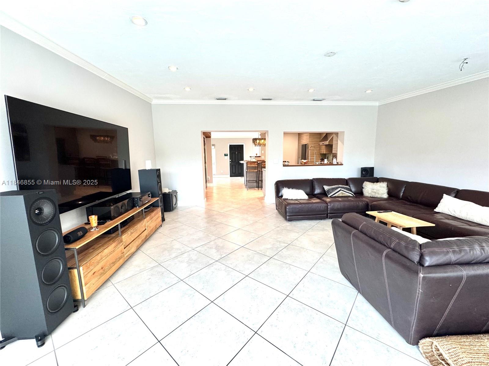 9385 Southwest 185th Street Cutler Bay, FL 33157 - Photo 24 of 27 a living room with furniture and a flat screen tv