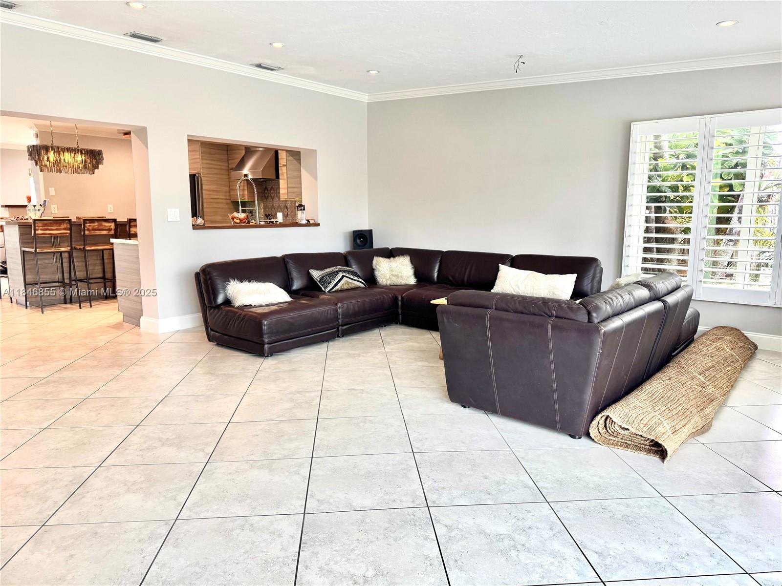 9385 Southwest 185th Street Cutler Bay, FL 33157 - Photo 25 of 27 a living room with furniture and a flat screen tv