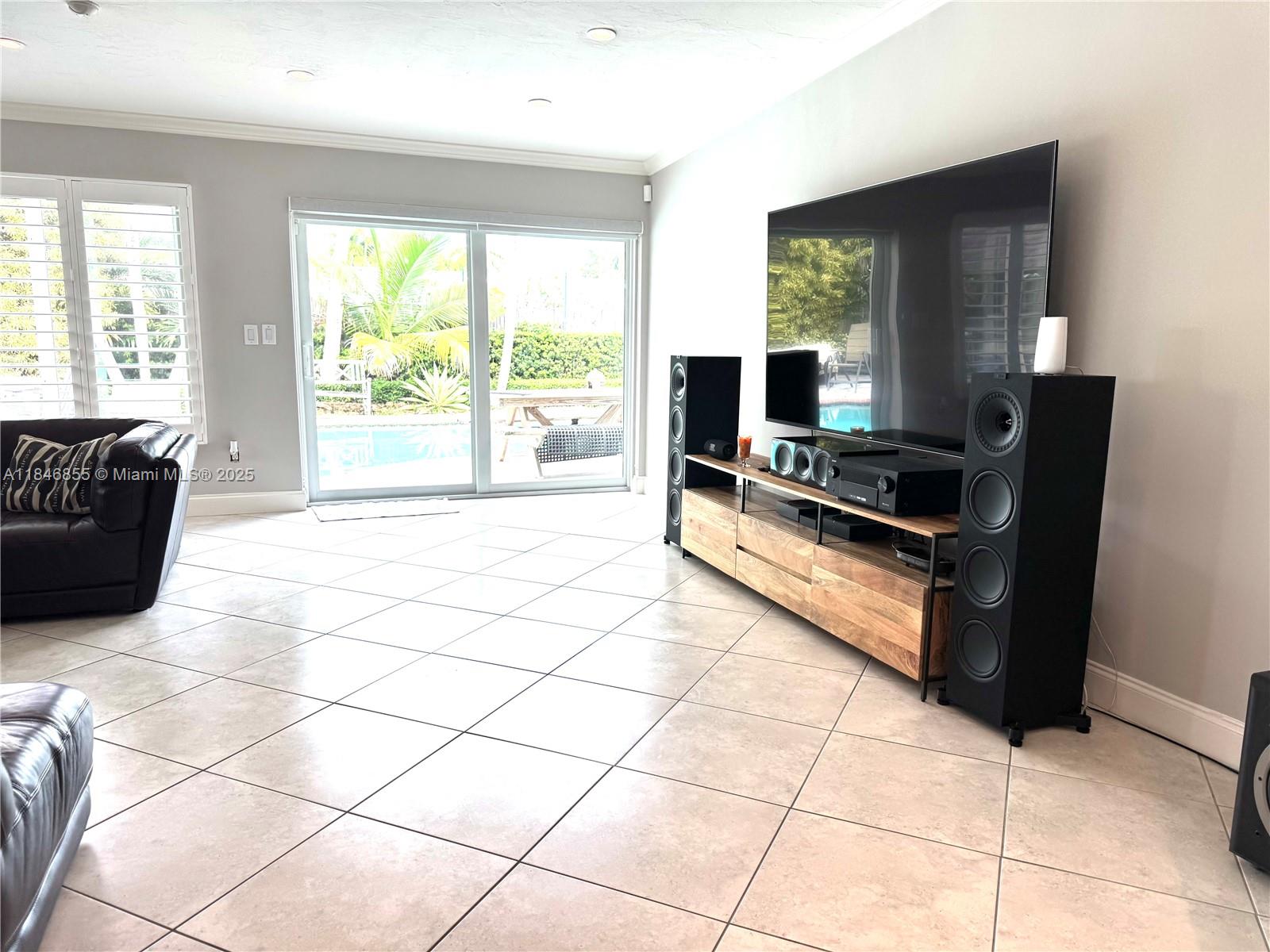 9385 Southwest 185th Street Cutler Bay, FL 33157 - Photo 27 of 27 a living room with furniture and a flat screen tv