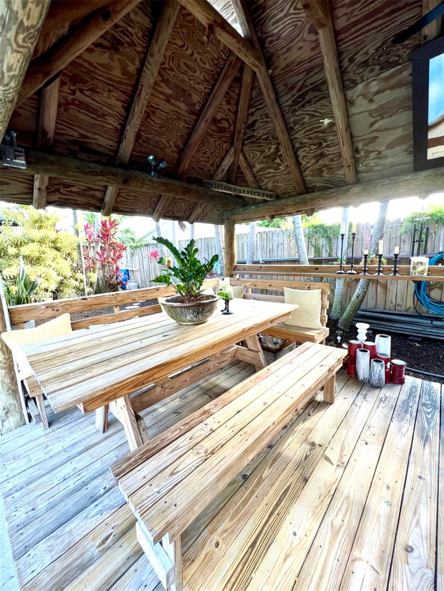 9385 Southwest 185th Street Cutler Bay, FL 33157 - Photo 8 of 27 a view of a porch with furniture and a table
