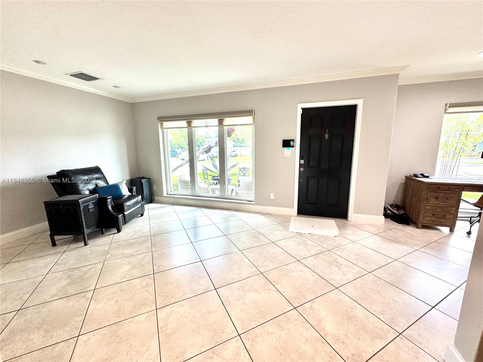 9385 Southwest 185th Street Cutler Bay, FL 33157 - Photo 10 of 27 a room with a bed and a large window