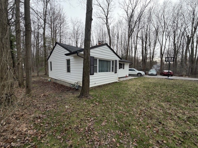 35180 Solon Road Solon, OH 44139 - Photo 5 of 33 View of side of home featuring crawl space, a chimney, and a yard