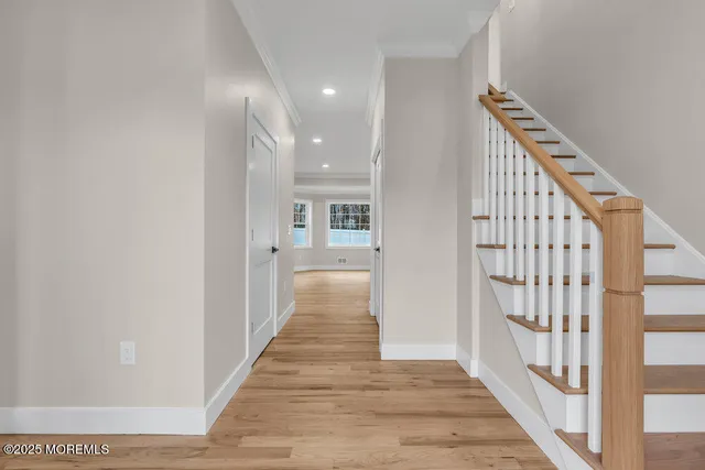 a view of entryway with wooden floor and stairs