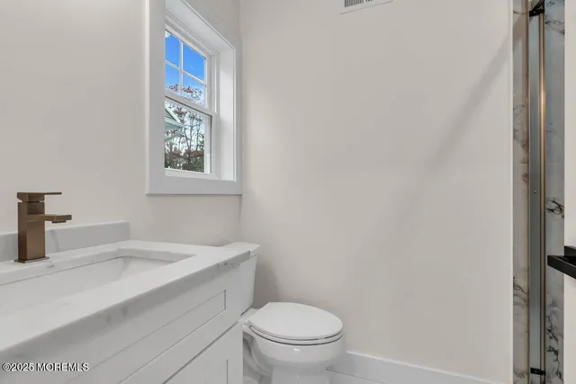 a large kitchen with stainless steel appliances kitchen island granite countertop a refrigerator a stove a sink and a center island