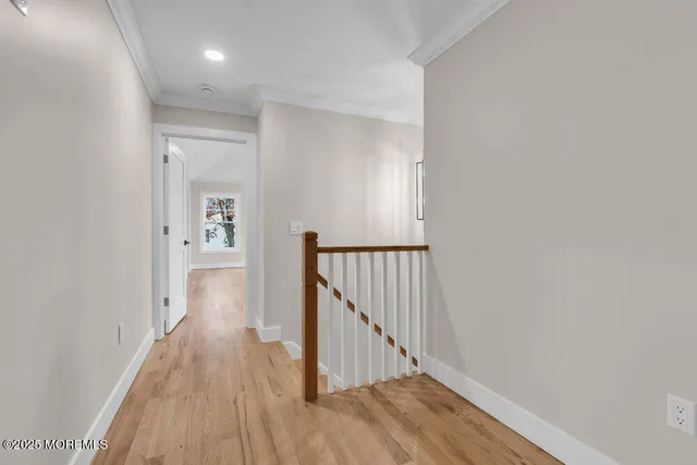 a view of empty room with wooden floor and window