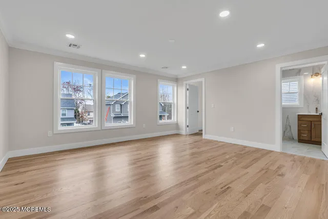 a spacious bathroom with a large tub sink and mirror