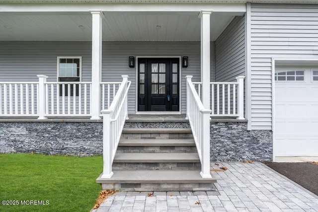 a view of a hallway with wooden floor and stairs