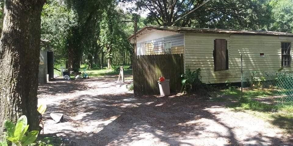 5410 Roberson Road Lakeland, FL 33810 - Photo 2 of 3 a view of a wooden house with a yard