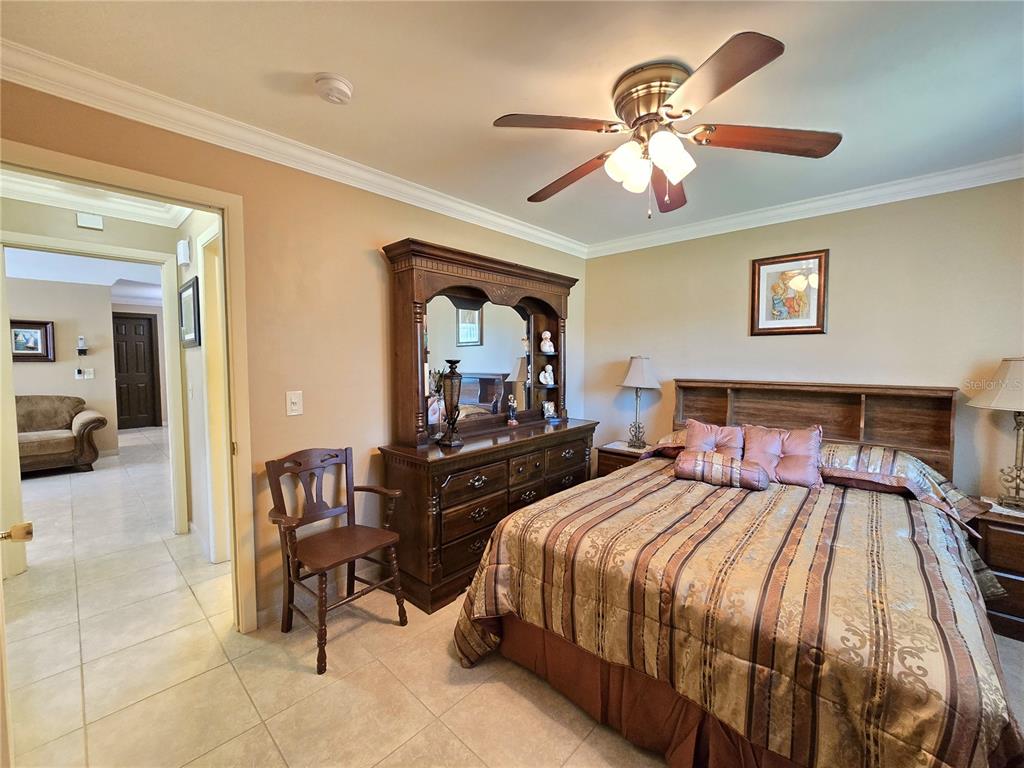 514 Brandon Avenue Clearwater, FL 33765 - Photo 16 of 67 a bedroom with a bed and a chandelier