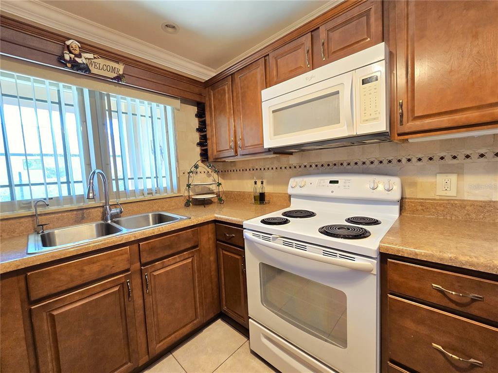 514 Brandon Avenue Clearwater, FL 33765 - Photo 6 of 67 a kitchen with a sink stove and cabinets
