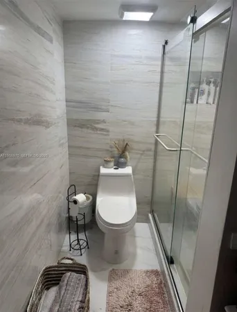 a bathroom with a toilet and a shower