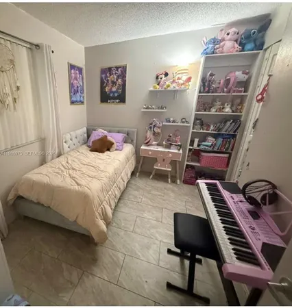 a bedroom with a bed and a piano