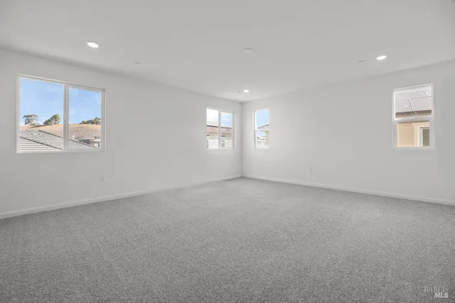 an empty room with windows and closet