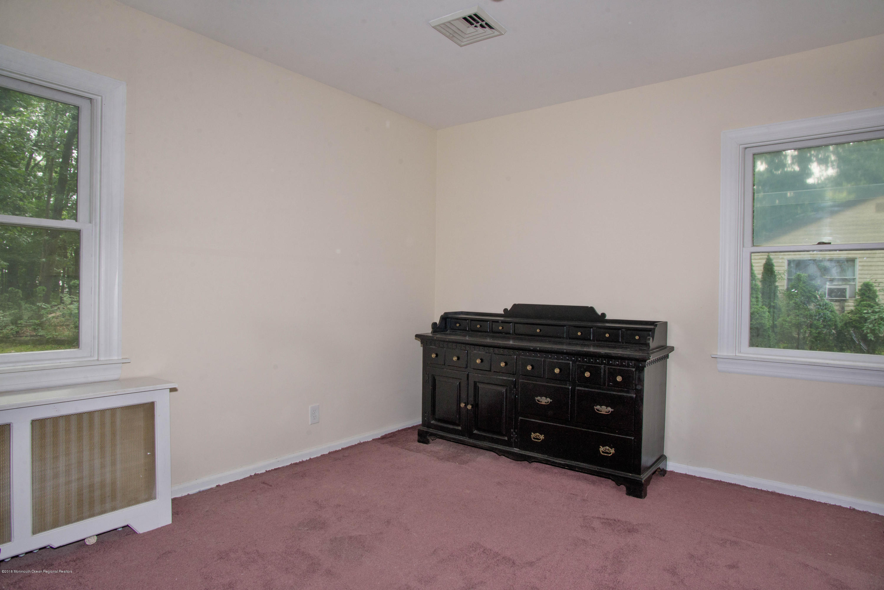 53 Fort Plains Road Howell, NJ 07731 - Photo 11 of 19 an empty room with a piano and wooden floor