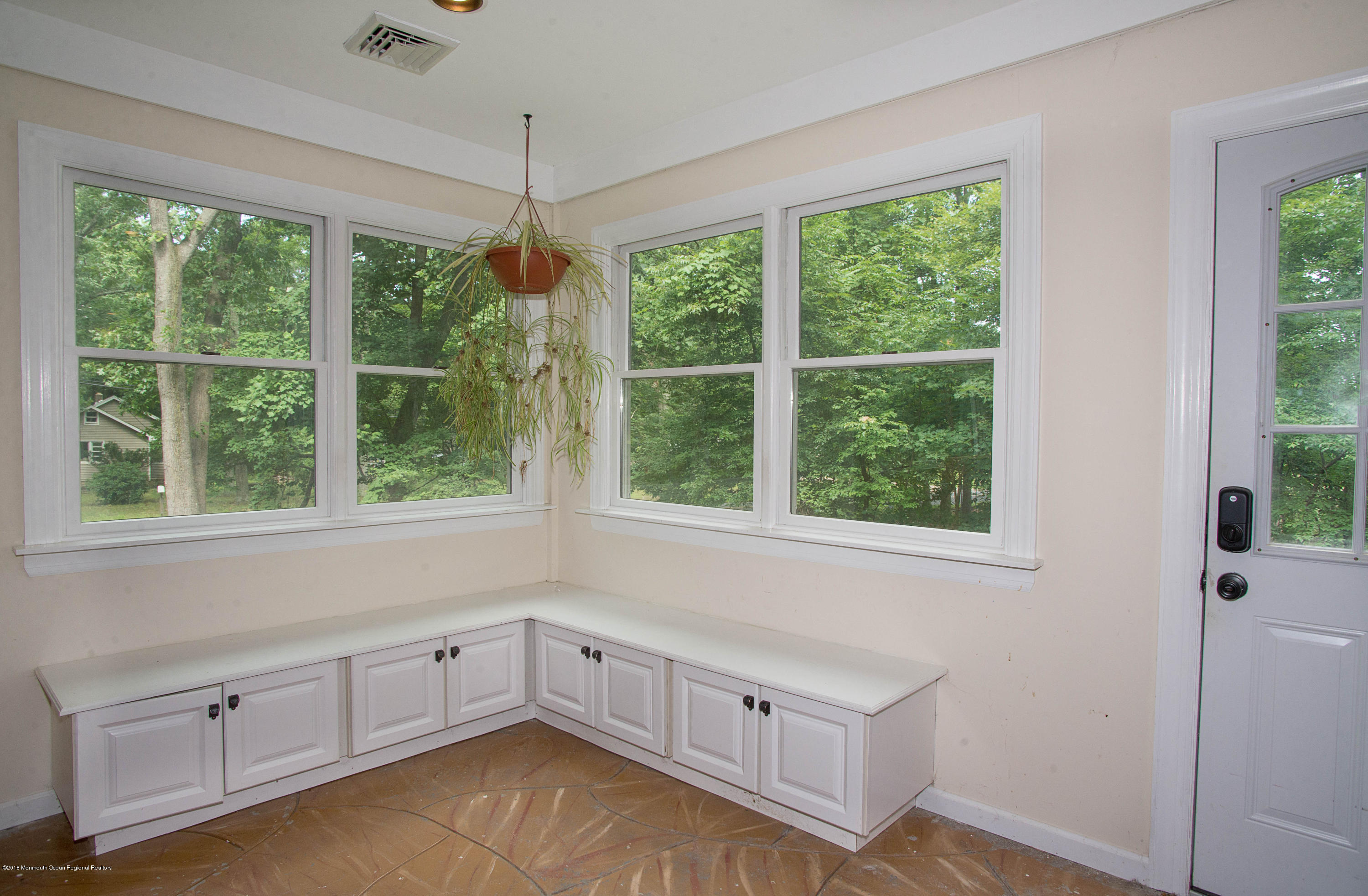 53 Fort Plains Road Howell, NJ 07731 - Photo 5 of 19 a kitchen with white cabinets and a large window
