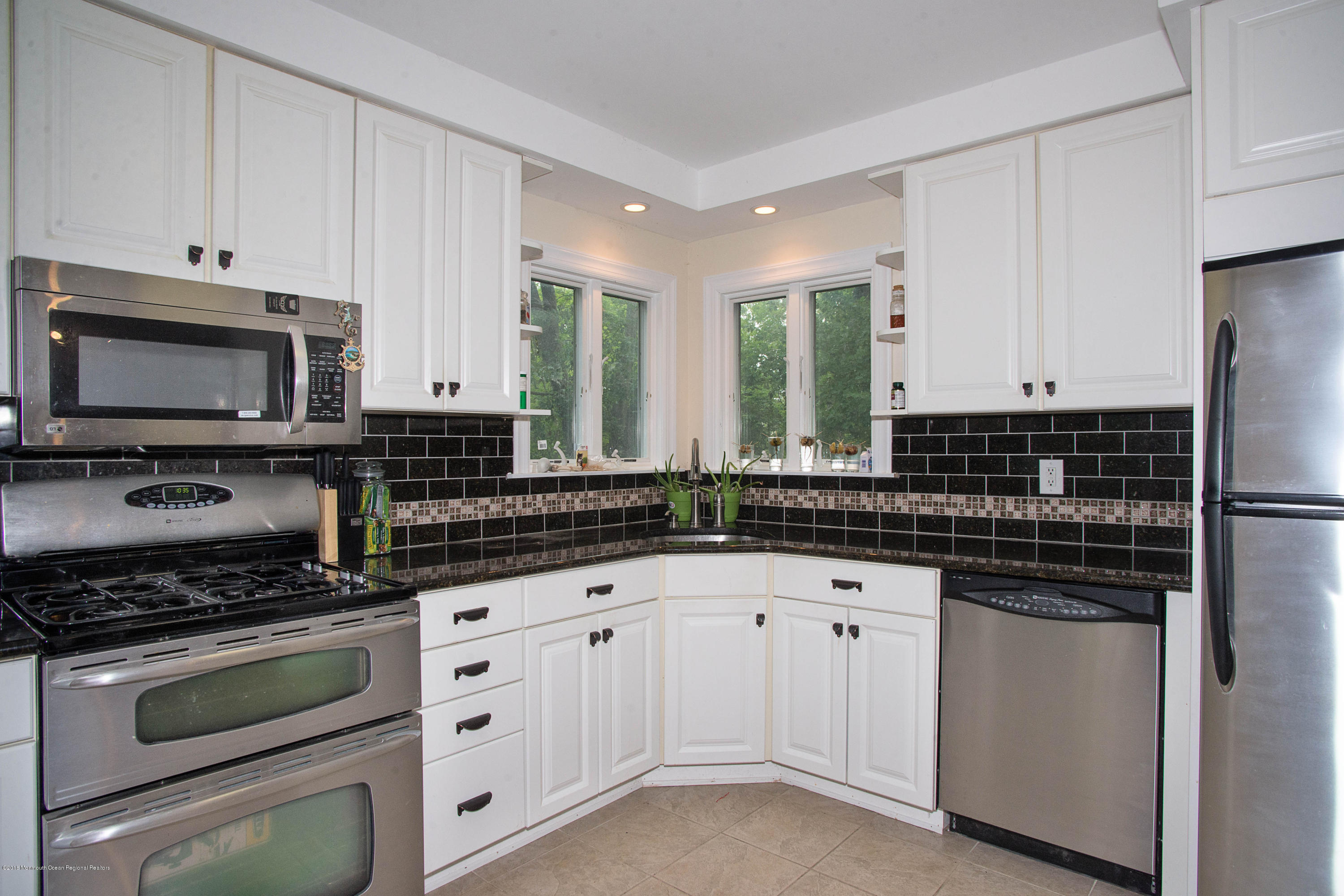 53 Fort Plains Road Howell, NJ 07731 - Photo 7 of 19 a kitchen with white cabinets and stainless steel appliances