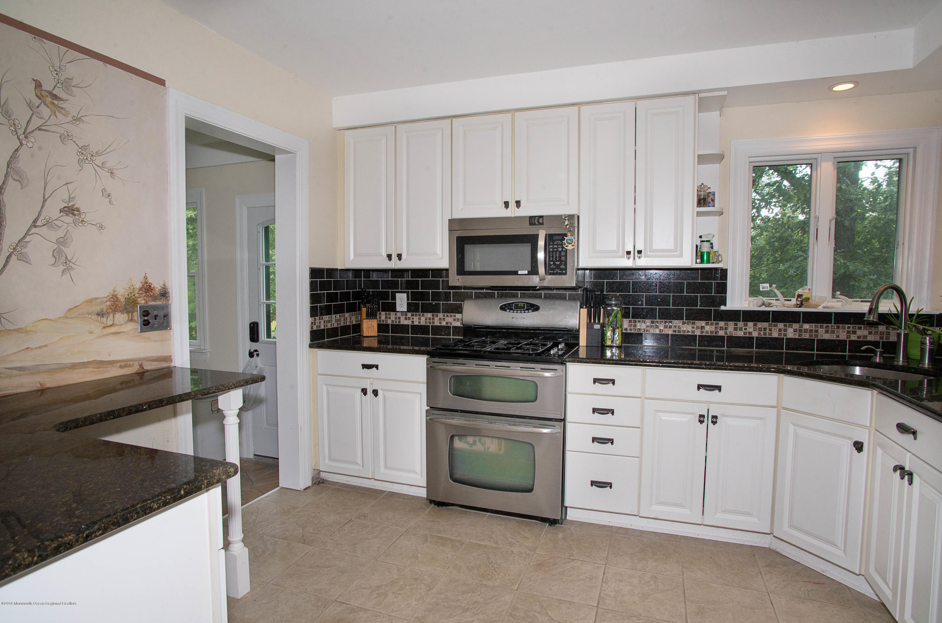 53 Fort Plains Road Howell, NJ 07731 - Photo 8 of 19 a kitchen with white cabinets and appliances