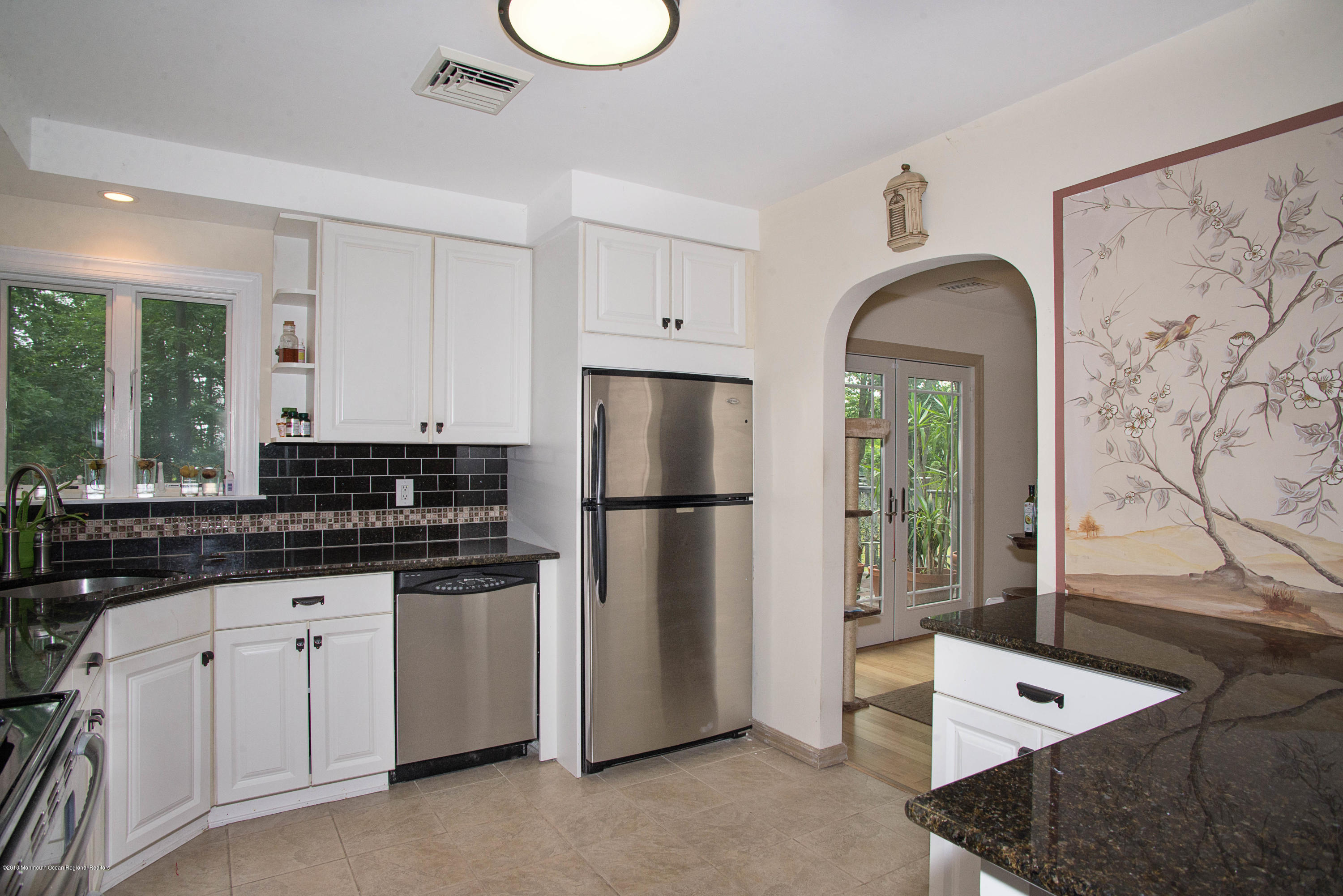 53 Fort Plains Road Howell, NJ 07731 - Photo 9 of 19 a kitchen with white cabinets and refrigerator