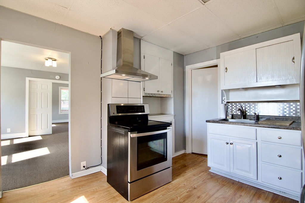 425 Taylor Street, Unit 1 Springfield, MA 01105 - Photo 11 of 25 a kitchen with cabinets and stainless steel appliances