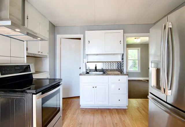 a kitchen with a refrigerator stove and sink