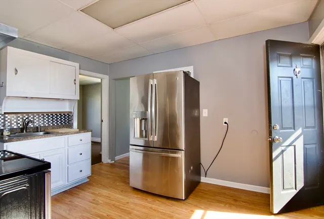 a kitchen with stainless steel appliances granite countertop a refrigerator and a stove