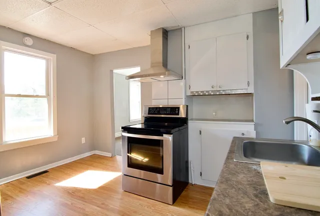 a kitchen with granite countertop a stove and a sink