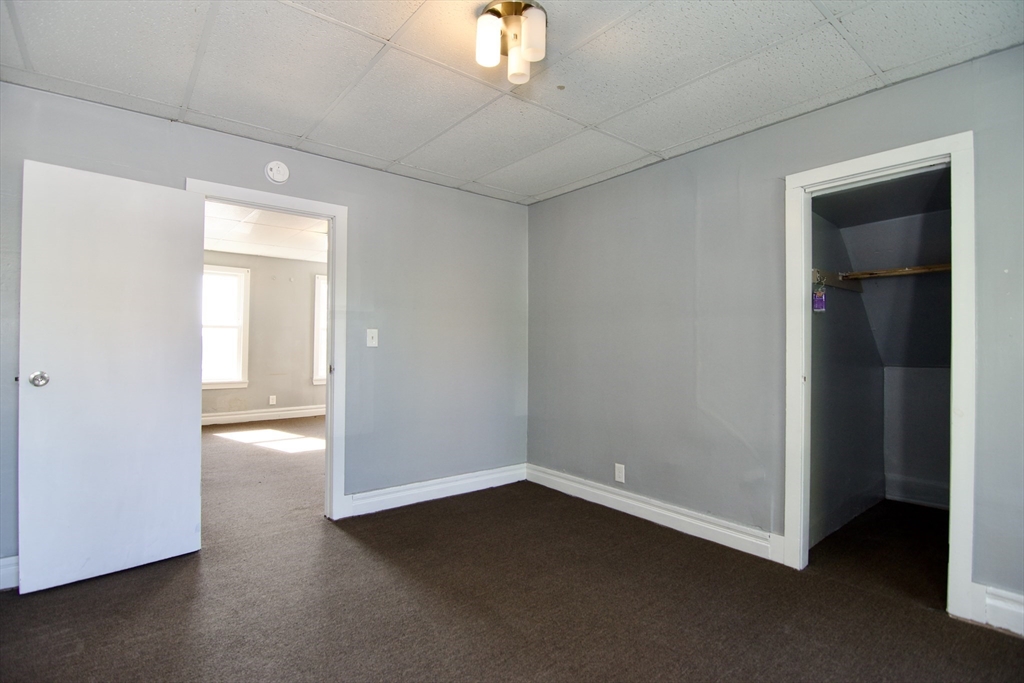 425 Taylor Street, Unit 1 Springfield, MA 01105 - Photo 18 of 25 an empty room with chandelier fan and windows
