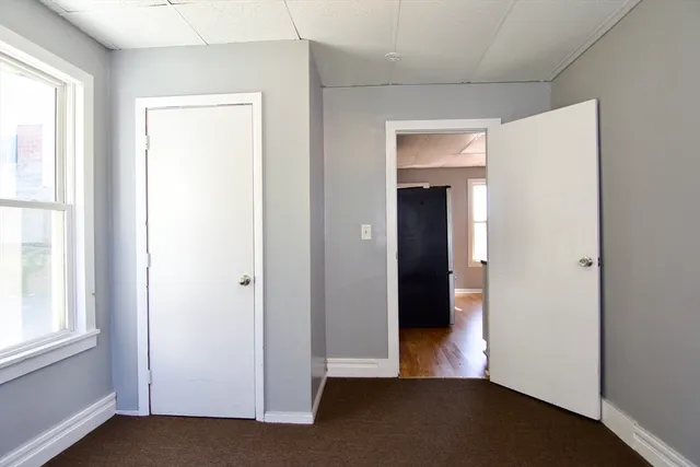 a view of a room with wooden floor