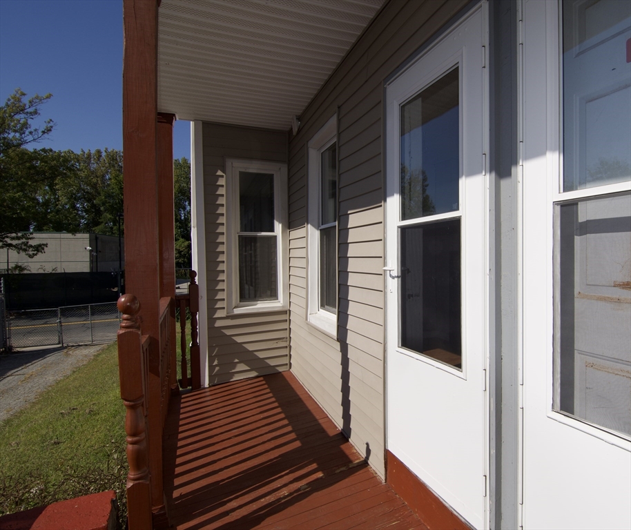 425 Taylor Street, Unit 1 Springfield, MA 01105 - Photo 25 of 25 a view of a balcony with wooden floor and potted plants
