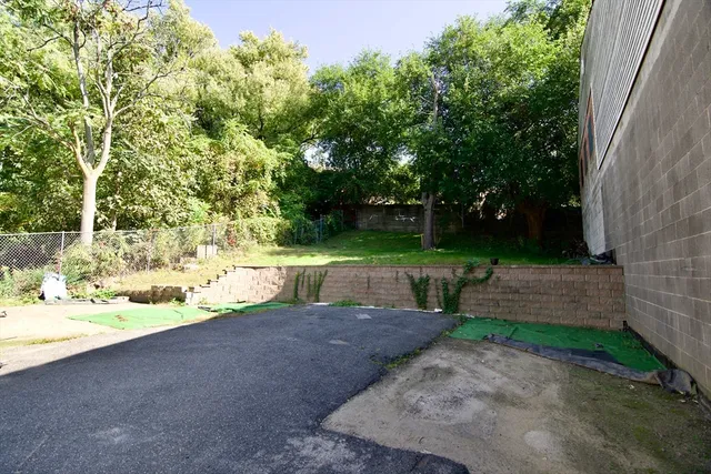 a view of a backyard with large trees