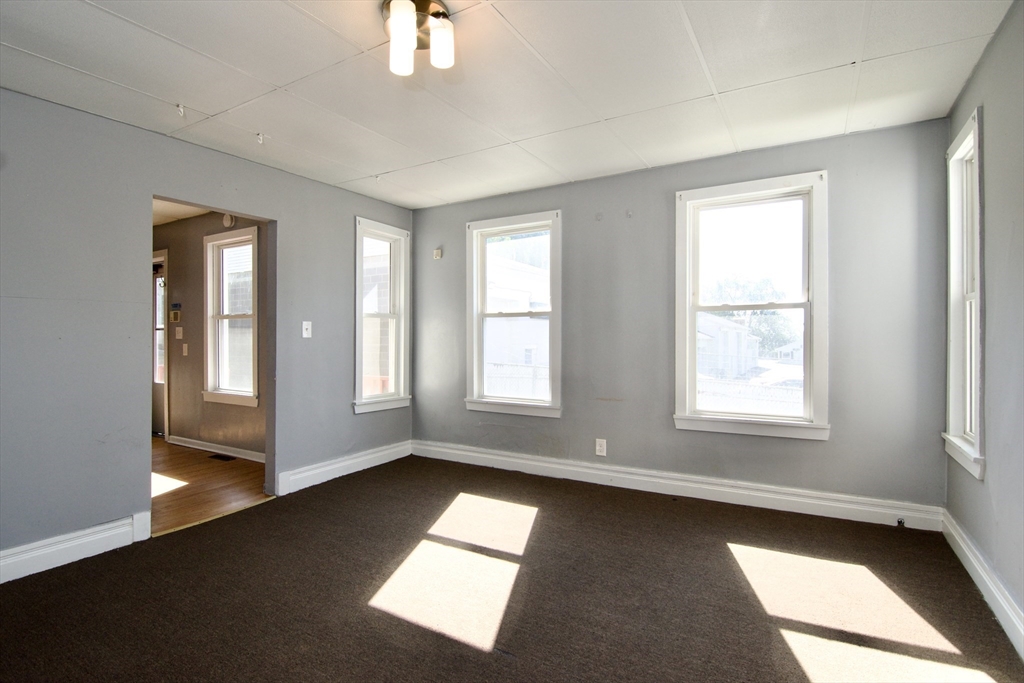 425 Taylor Street, Unit 1 Springfield, MA 01105 - Photo 8 of 25 a view of empty room with wooden floor and fan