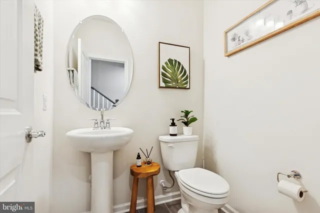 a white toilet sitting next to a bathroom sink