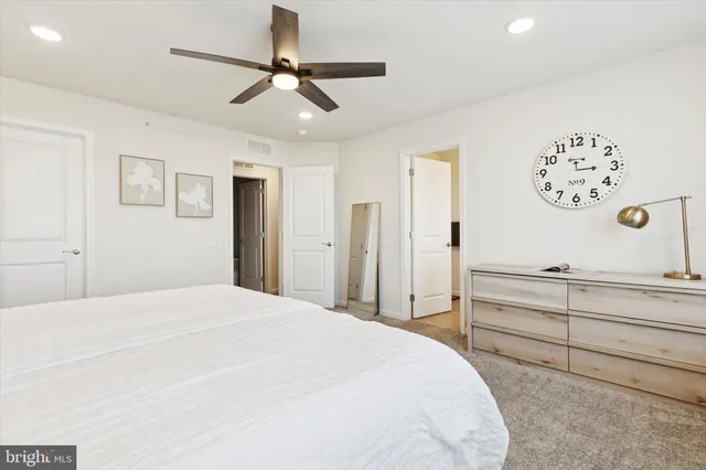 a bedroom with a large bed and a dresser