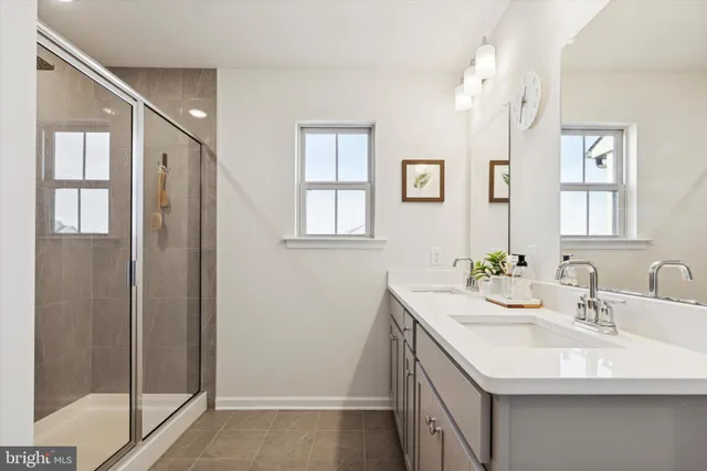 a bathroom with a sink a mirror and a shower