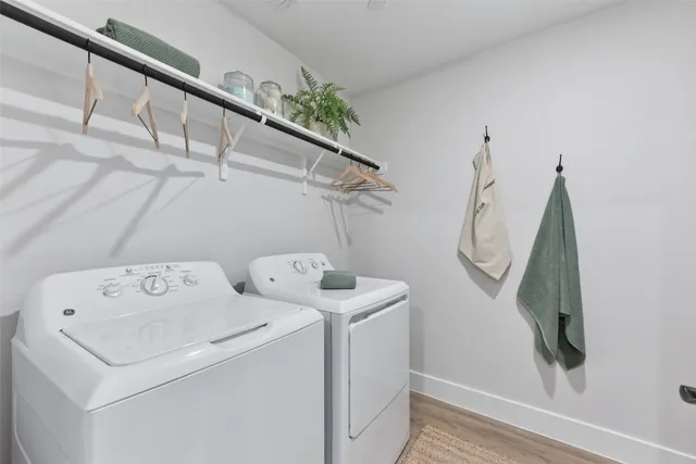 a living room with kitchen island furniture a wooden floor and a sink