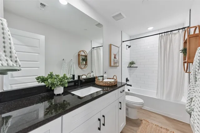 a view of a workspace with furniture and wooden floor
