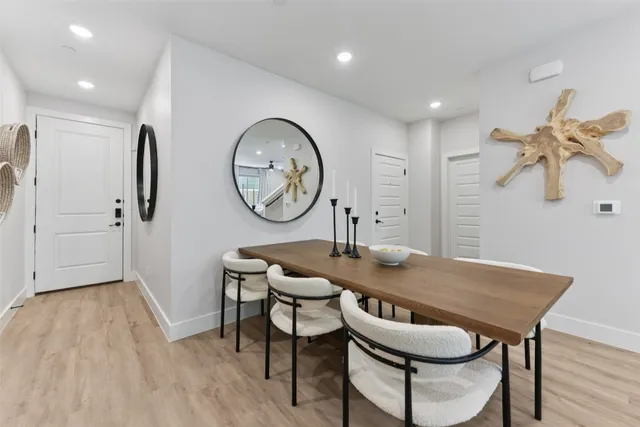 a view of a dining room with furniture and a chandelier