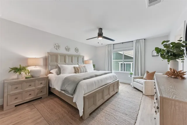 a bedroom with a bed next to a window with the outer view