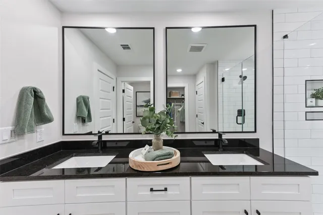 a spacious bedroom with a bed a couch and a chandelier