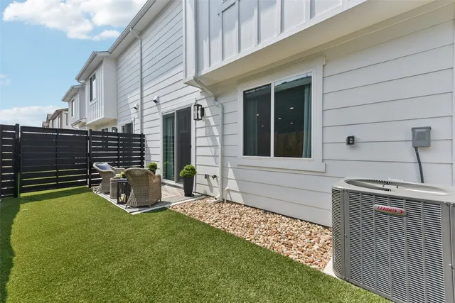 an empty room with a ceiling fan and window