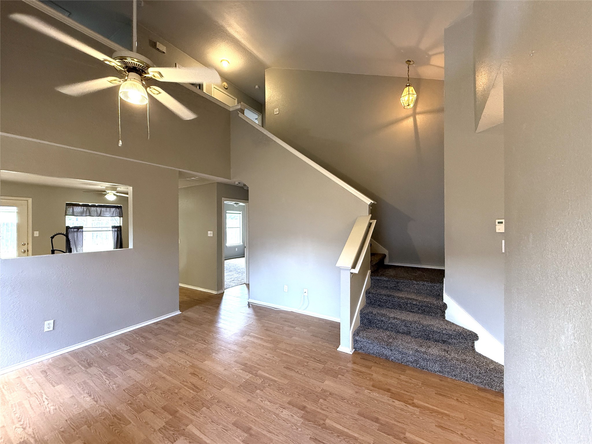 2120 Jester Farms Road Round Rock, TX 78664 - Photo 4 of 28 A split-level interior with a bright living area seamlessly transitions to a carpeted staircase.