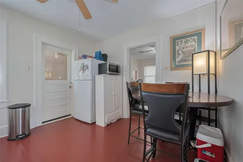 a dining room with furniture and wooden floor