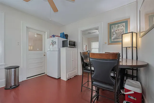 a dining room with furniture and wooden floor
