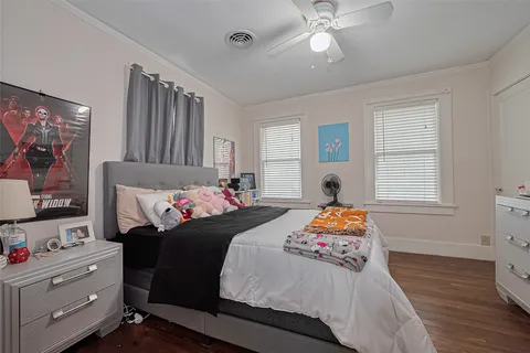 a bedroom with bed and windows