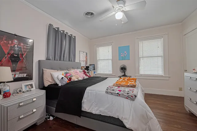 a bedroom with bed and windows